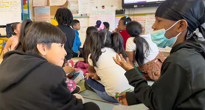 Students build knowledge together during a MORE classroom lesson