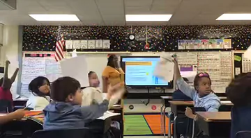 Students show and share their guesses about how many bones are in an adult human body